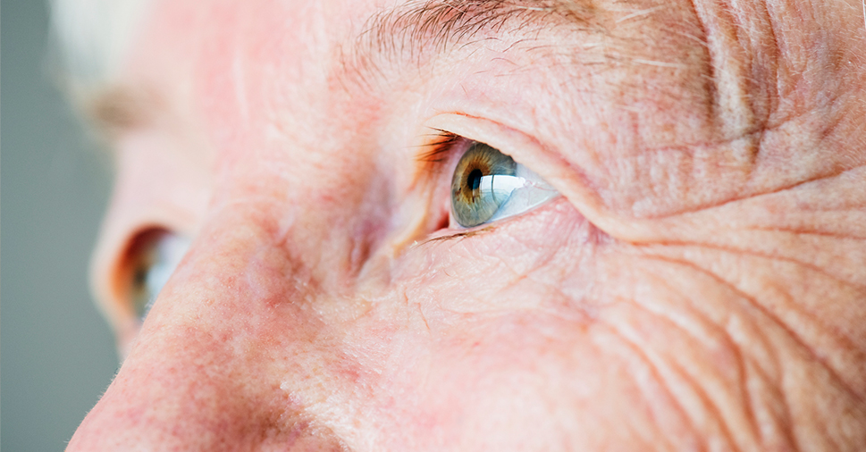 A closeup of a side profile of an elderly's person's hazel eyes.