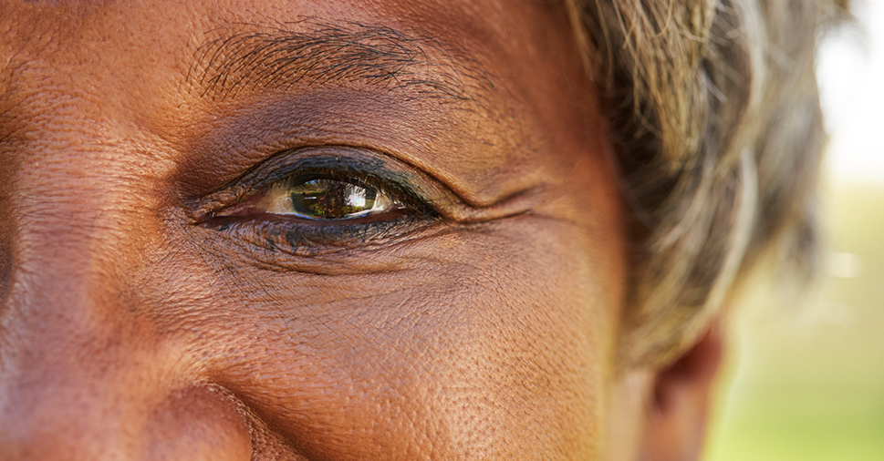 A closeup of a smling lady's eye.