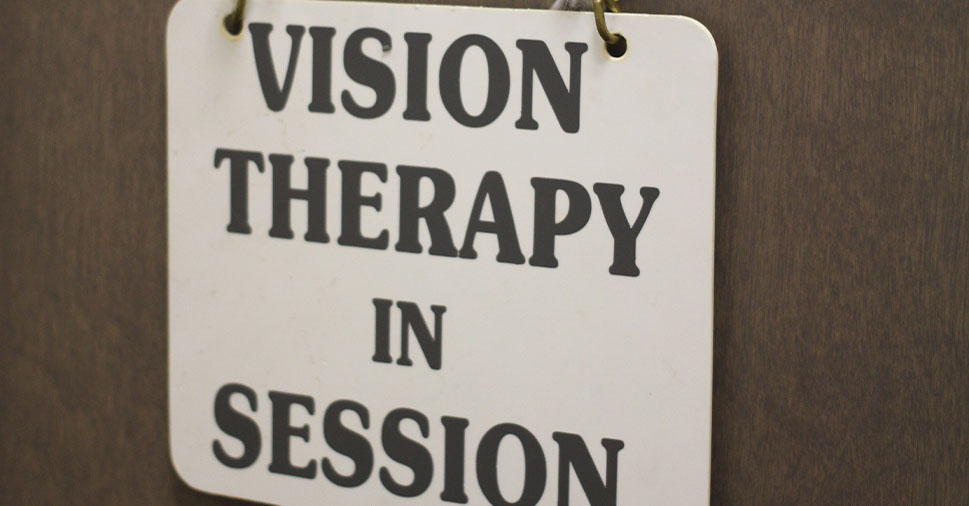 A sign on a door in the Roswell Eye Clinic that says Vision Therapy in Session.