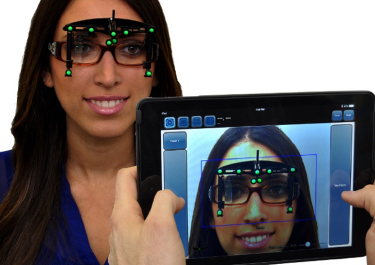 Lady with optikam on glasses and an ipad viewing them